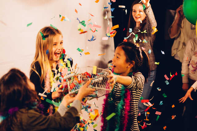 children surrounded by confetti