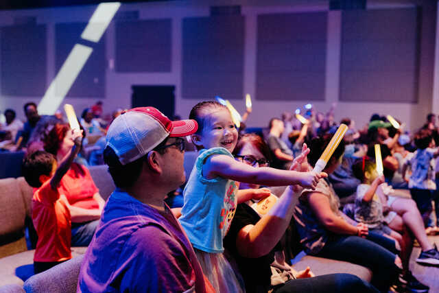 preschooler and family playing with light wands at playhouse family show