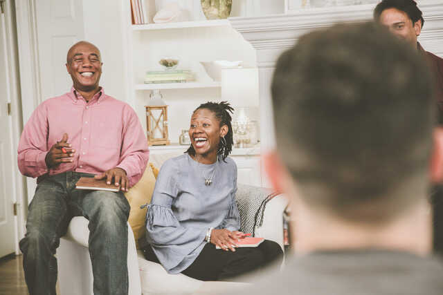 married couple laughing and enjoying small group