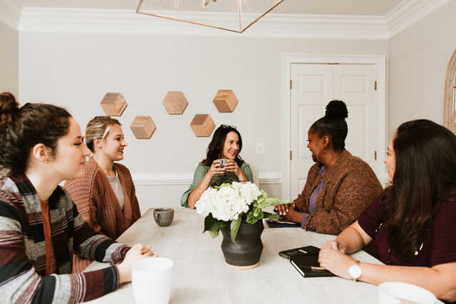 women at a table having a discussion
