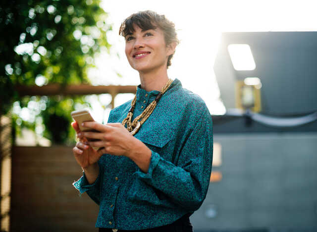 smiling woman holding a cell phone